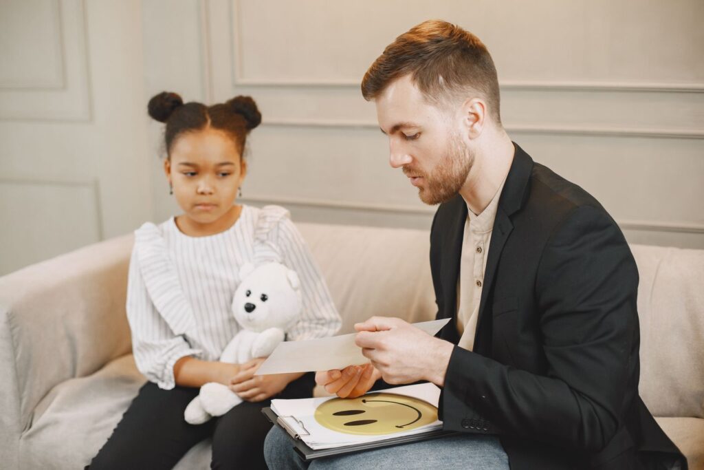 Child with a therapist and her parent during a session