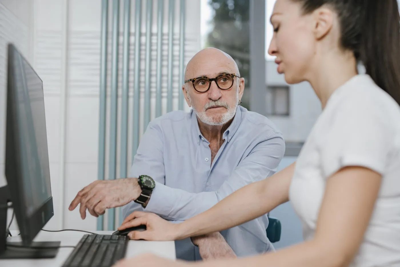 Older patient reviewing his treatment with a clinician