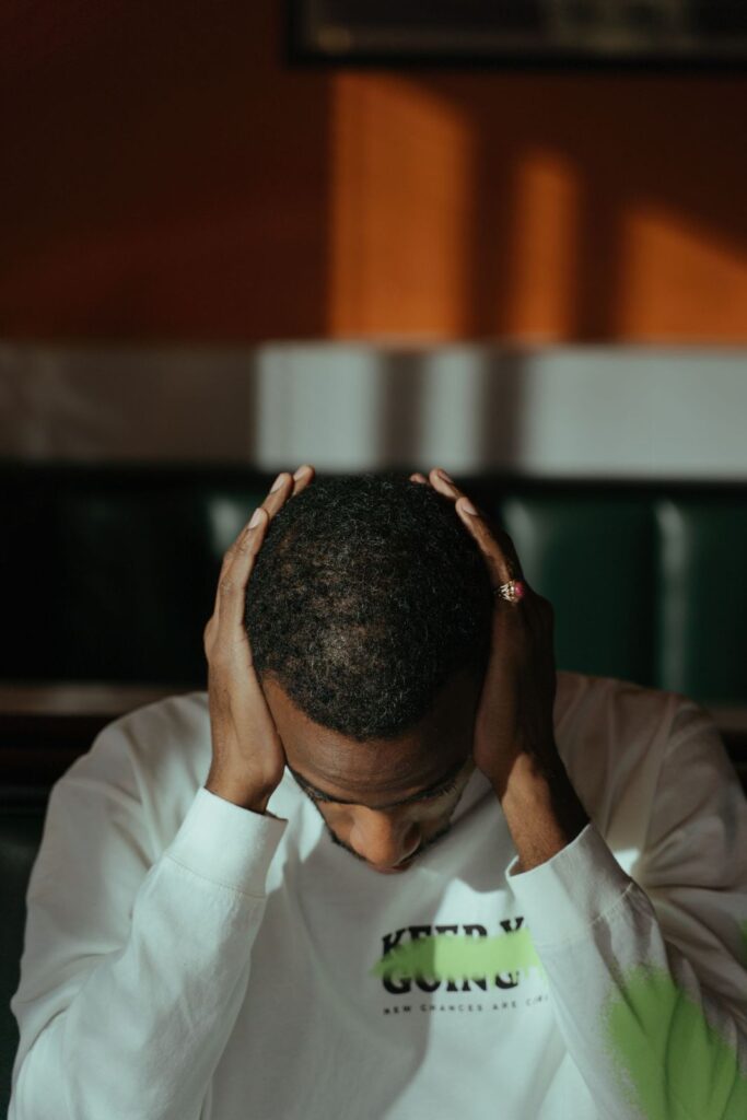 Man holding his head in his hands