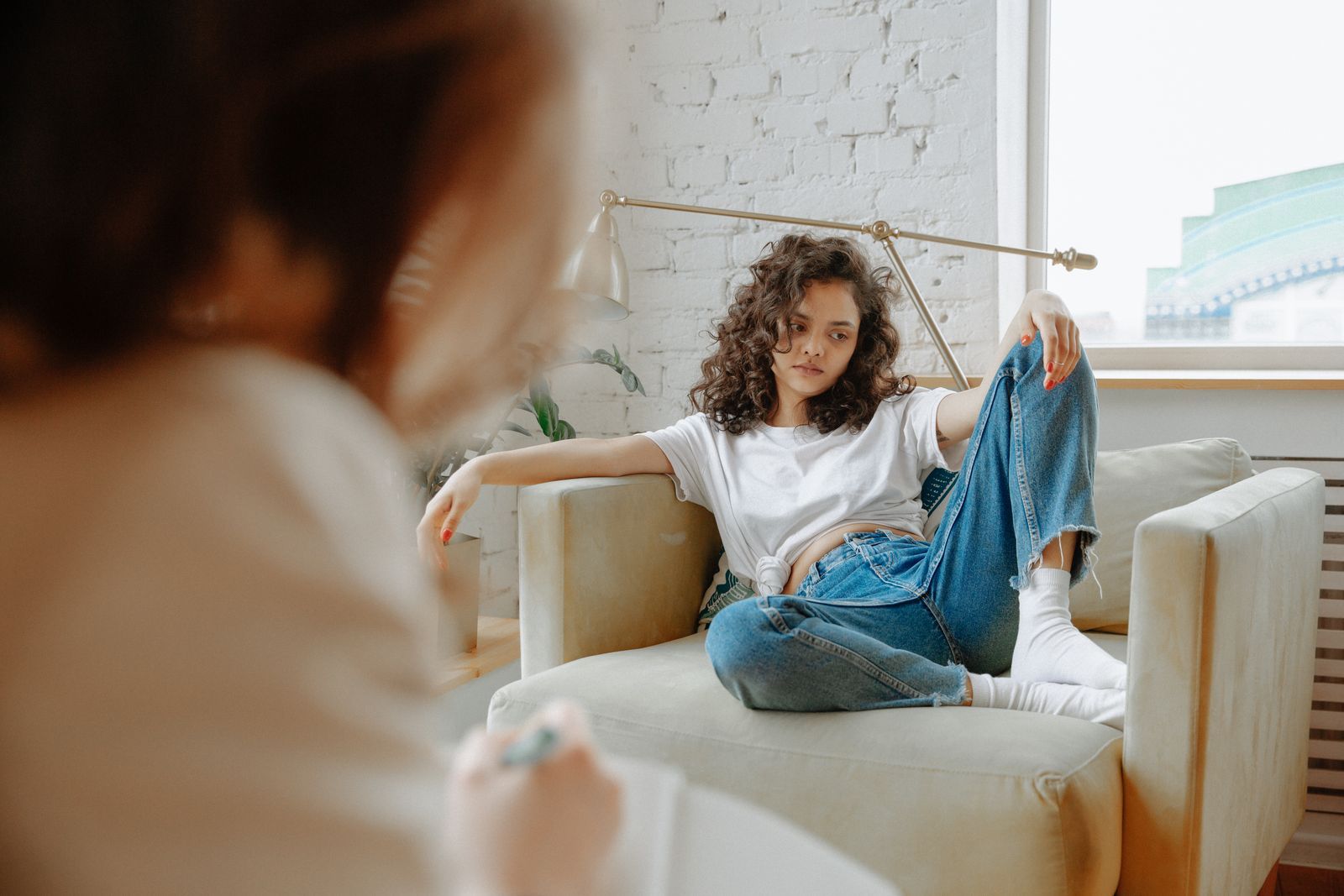 Young woman relaxed on a sofa during an individual therapy session