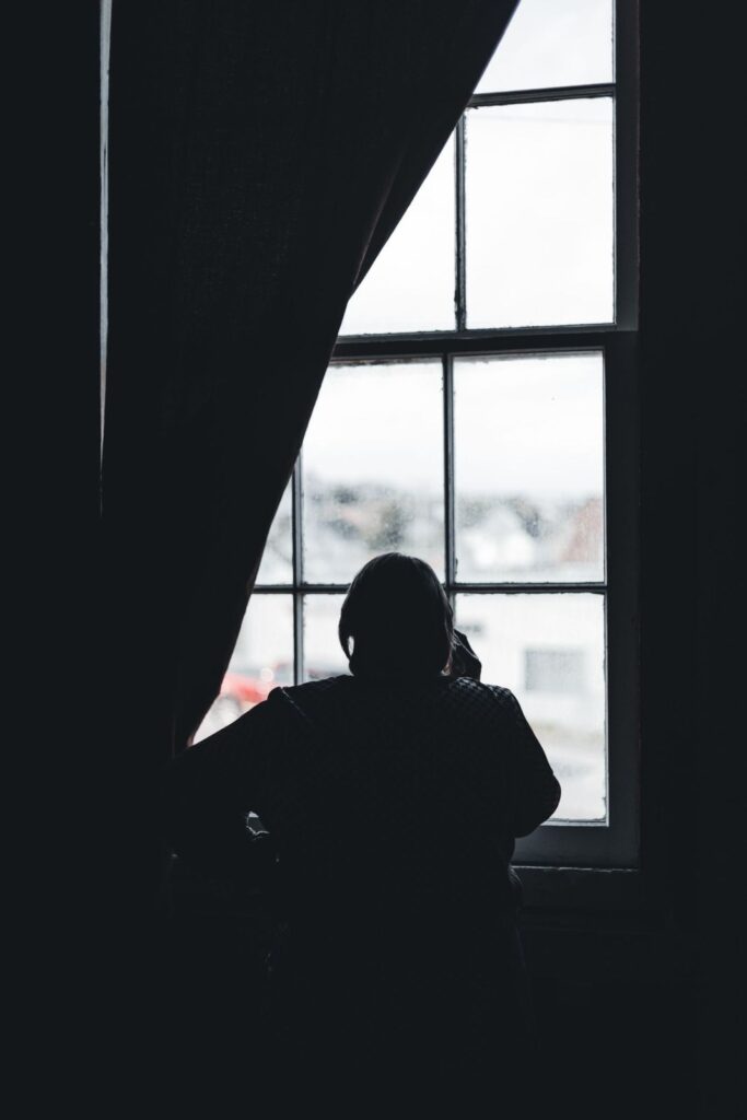 Silhouette of a person by a window